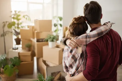 Couple Embracing in Bright New Apartment