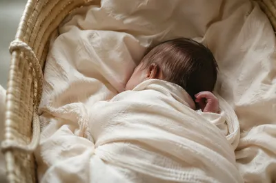 Peaceful Newborn Sleeping in Cream Blanket