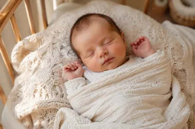 Sleeping Newborn on Knit Blanket