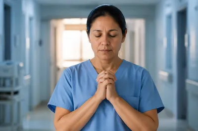 Nurse Praying in Quiet Hospital Corridor