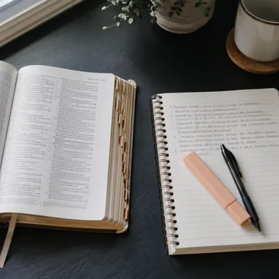 Open Bible and Handwritten Scripture Notebook