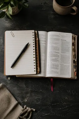 Open Notebook Beside Scripture Study Pages