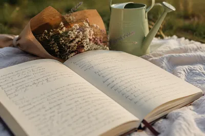 Open Notebook on Blanket with Dried Flowers