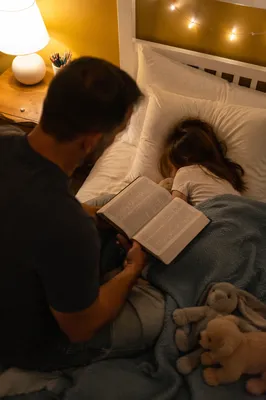 Parent Reading Bible to Child at Bedtime