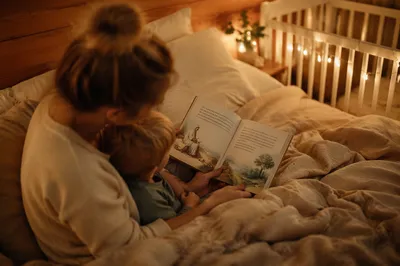 Parent Reading Bible to Child at Bedtime