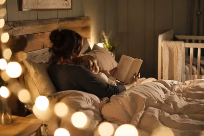 Parent Reading Bible to Child at Bedtime