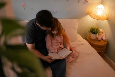 Parent Reading Bible to Child at Bedtime
