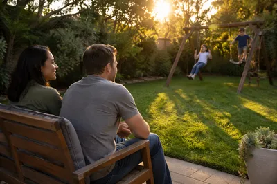 Parents Watching Children in Backyard at Sunset
