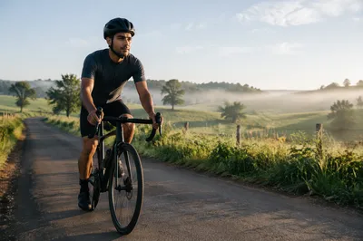 Young Man Cycling Through Green Countryside