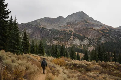 Lone Hiker on Mountain Trail