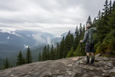 Lone Hiker Overlooking Misty Mountain Valley