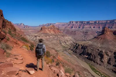Lone Hiker Overlooking Vast Desert Canyon