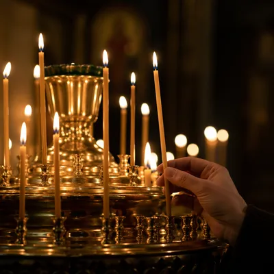Hand Lighting Candle in Quiet Chapel