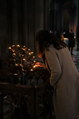 Candlelit Prayer in a Dark Historic Church
