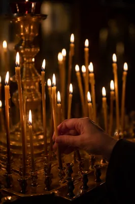 Hand Lighting Candle in Quiet Chapel