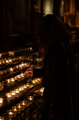 Lighting a Votive Candle in Dark Church