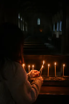Candlelit Prayer in a Dark Chapel