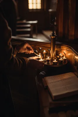 Lighting Votive Candle in Quiet Chapel
