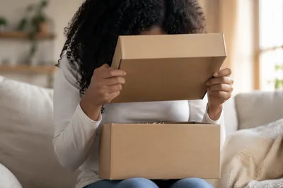 Joyful Surprise Opening a Kraft Gift Box