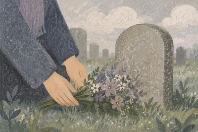 Hands Placing Wildflowers at Quiet Grave Memorial
