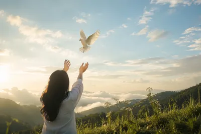 Releasing White Dove at Sunrise Hillside