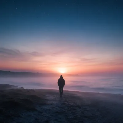 Silhouette Walking Through Fog Toward Dawn Light