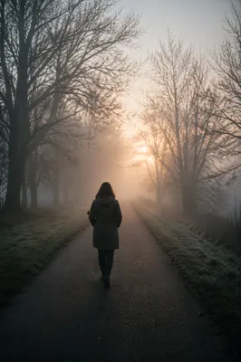 Person Walking Through Fog Toward Light