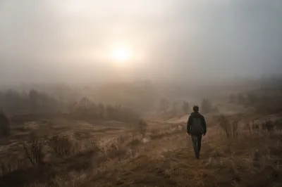 Solitary Walk Toward Light in Morning Fog