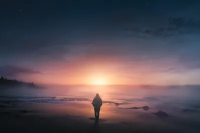 Silhouette Walking Through Coastal Fog Toward Dawn