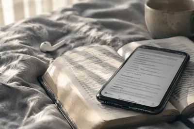 Smartphone on Open Bible in Morning Light