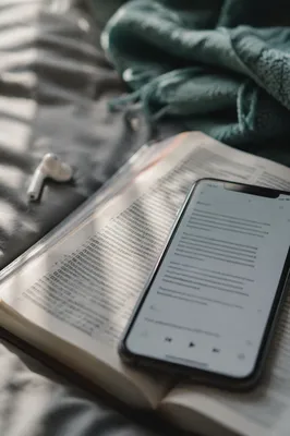 Smartphone on Open Bible With Earbud