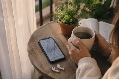 Smartphone and Earbuds on Morning Balcony Table