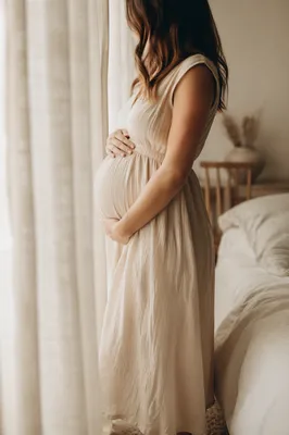 Pregnant Woman by Window in Soft Light