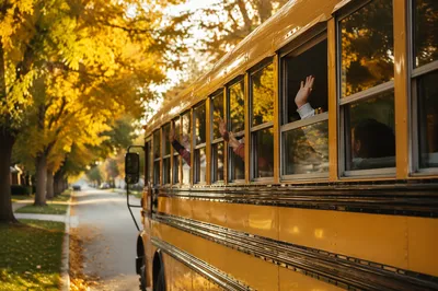 Children Waving from Yellow School Bus