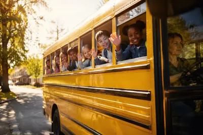 Children Waving from Yellow School Bus