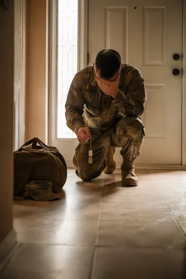Soldier Kneeling in Prayer with Dog Tags