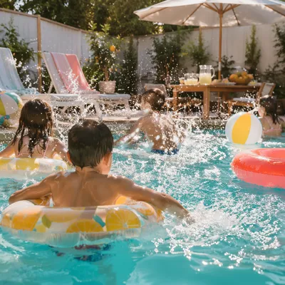 Cheerful Kids Splashing at Summer Pool Party