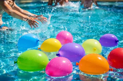 Colorful Water Balloons in Sunny Pool