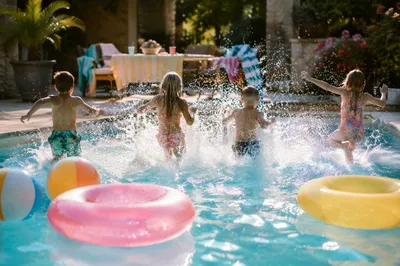 Cheerful Kids Splashing at Summer Pool Party