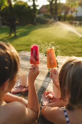 Kids Laughing with Summer Popsicles Outdoors