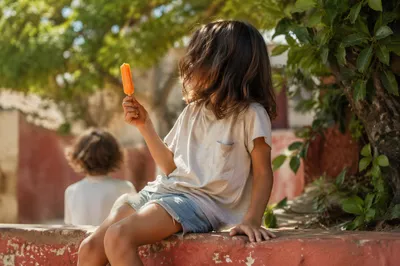 Laughing Child with Summer Popsicle Outdoors