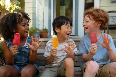 Children Eating Popsicles on Porch Steps