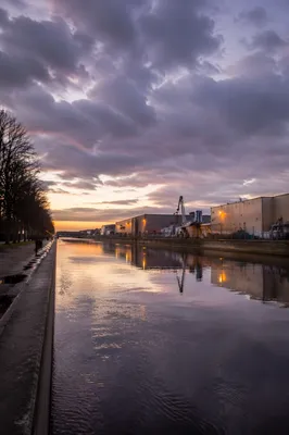 Peaceful Urban Canal Sunrise After Storm