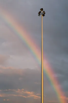 Rainbow Sunrise Over Post Storm Light Pole