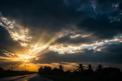 Peaceful Sunrise Breaking Through Storm Clouds