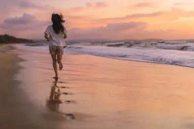 Barefoot Sunset Run Along Quiet Shoreline