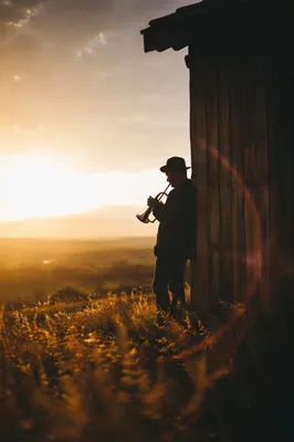 Silhouette at Sunset Beside Rural Shed