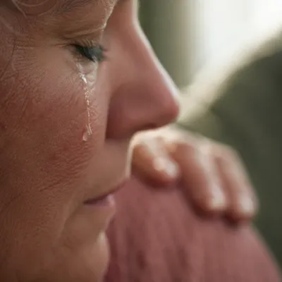 Tearful Cheek Close Up With Comforting Presence
