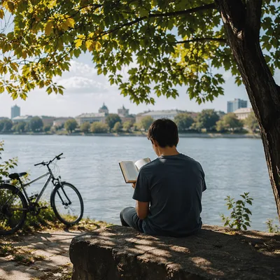 Teen Reading Bible Beneath Riverside Tree