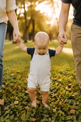 Toddler First Steps with Parents in Park